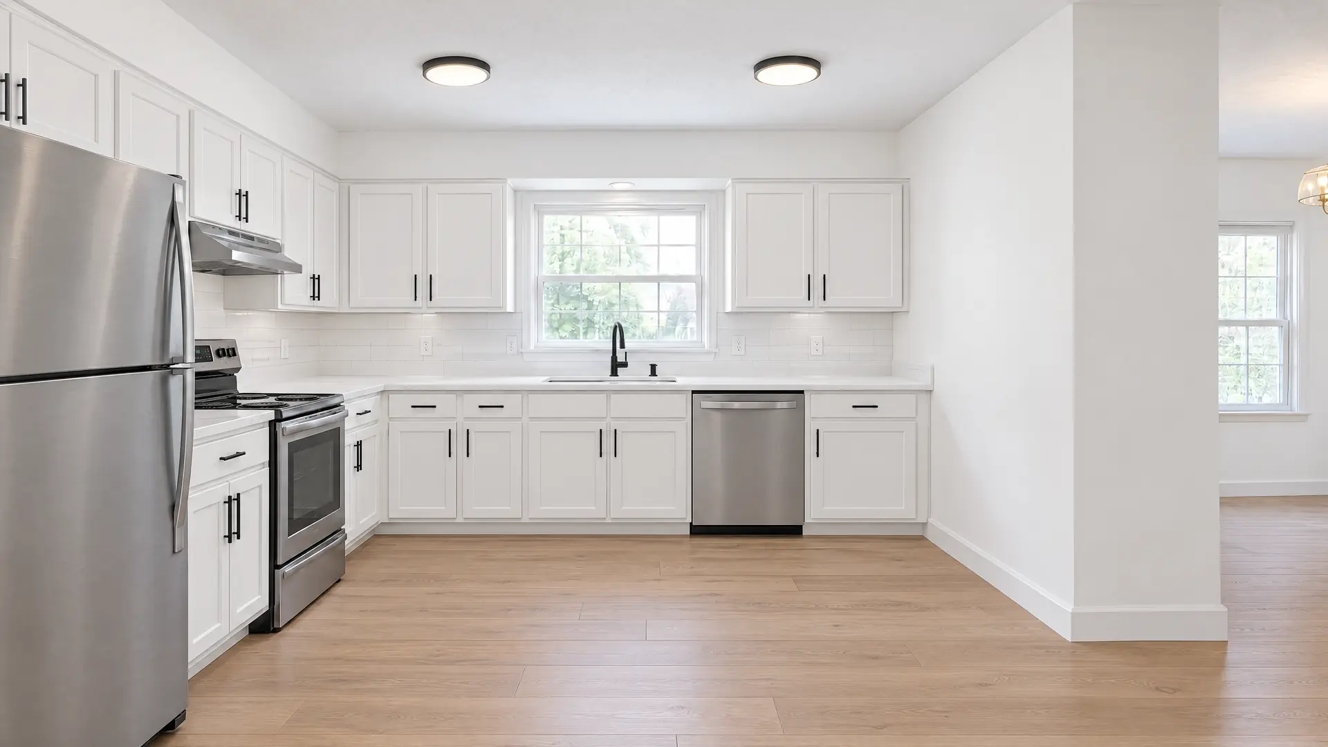 Illustration of the same kitchen after a refresh, with painted white cabinets, quartz counters and stainless appliances